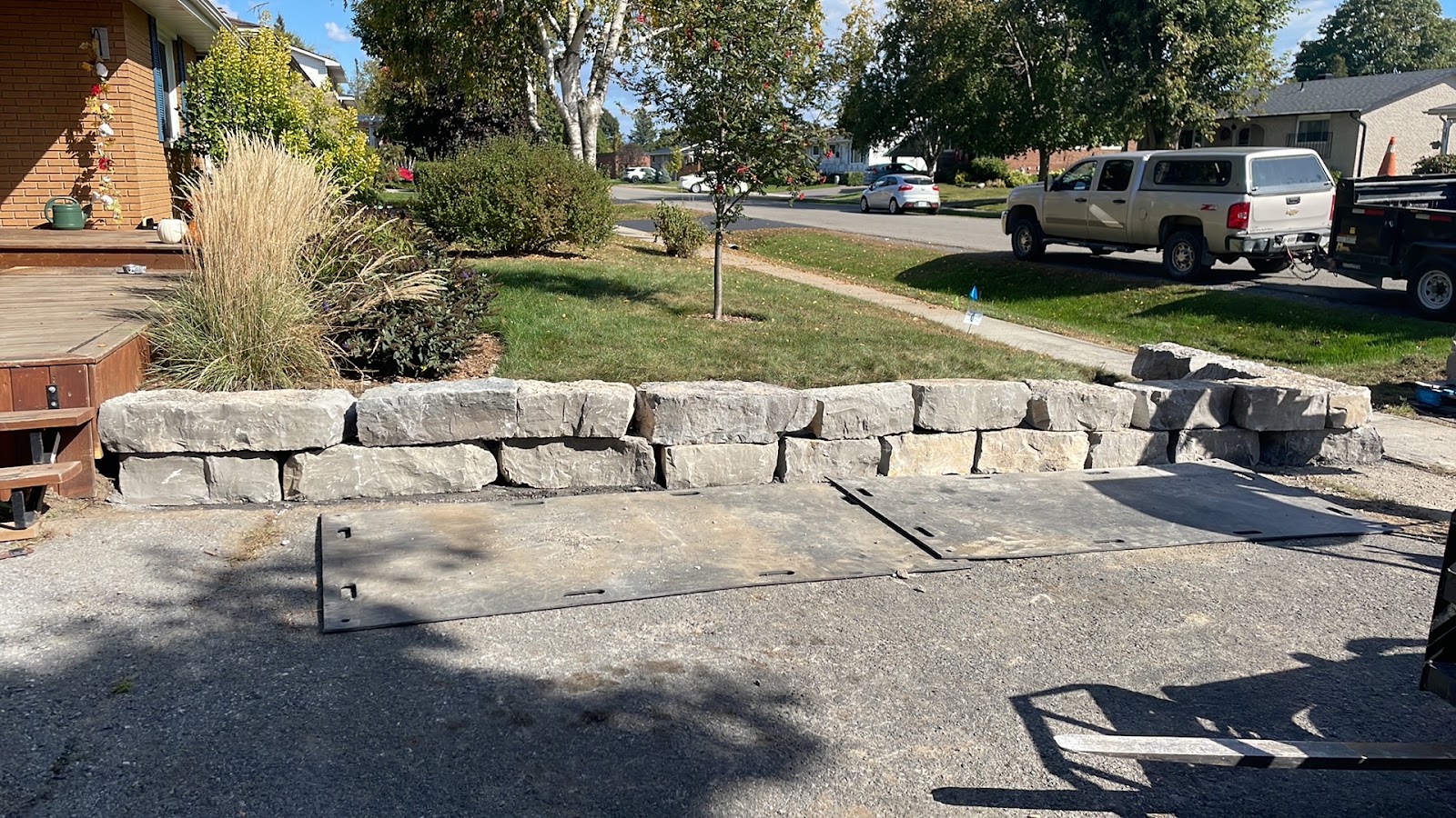 Armour stone retaining wall beside a new driveway on a Cornwall, Ontario property