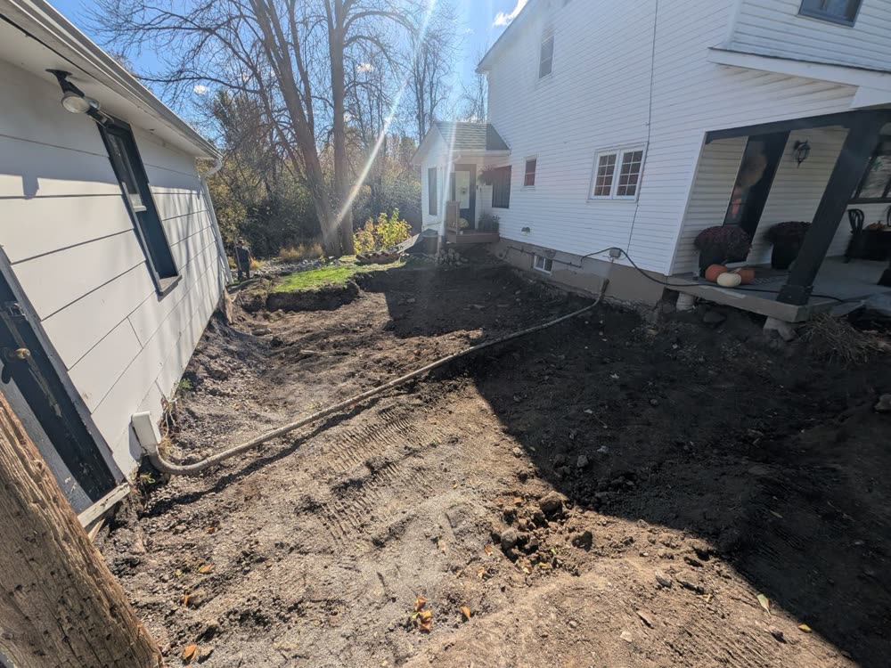 Yard between a house and garage dug out for a new interlock patio