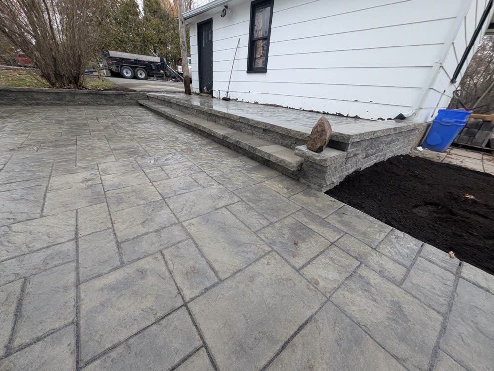 Finished interlock landing and steps with retaining wall and new topsoil