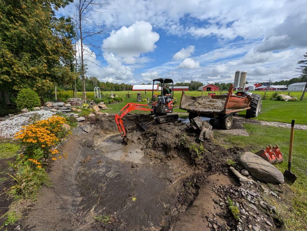 SD&G mini excavator digging out a pond and loading a tractor wagon near Ingleside, Ontario
