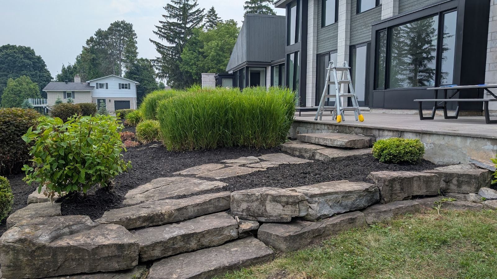Natural stone steps set into a planted garden slope